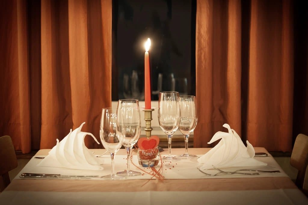 Table set for a romantic dinner with candles and flowers